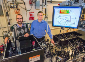 Giacomo Coslovich (left) and Robert Kaindl (right) next to the laser setup that generates extremely short pulses of light at “mid-infrared” wavelengths, far beyond the spectrum perceptible by the human eye.