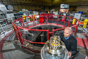 Sandia National Laboratories physicist Thomas Awe examines coils that reduce plasma instabilities in the quest for controlled nuclear fusion at Sandia’s Z machine. (Photo by Randy Montoya)