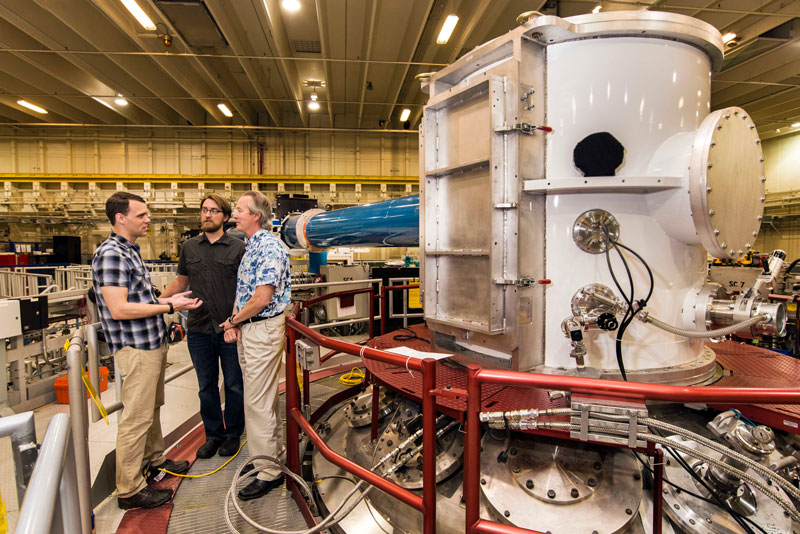 At the heart of Sandia National Laboratories’ Z machine, Matt Gomez, left, presents an idea to Steve Slutz, right, while Adam Sefkow looks on. (Photo by Randy Montoya)